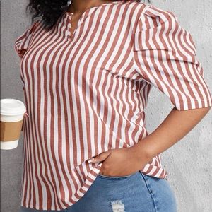 Linen striped blue and white top. It has puffed sleeves.